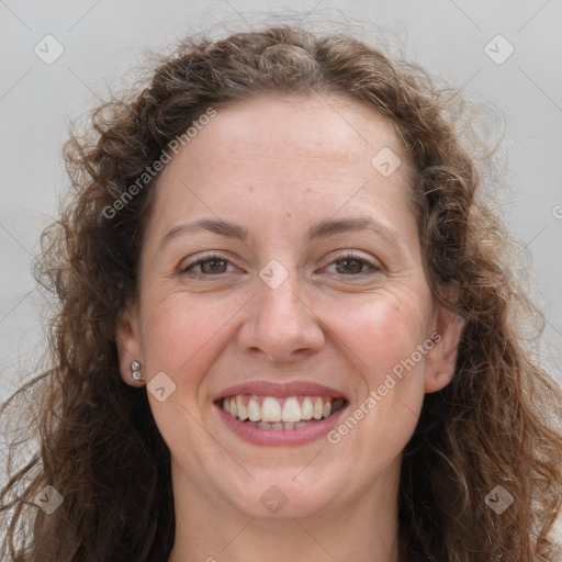 Joyful white adult female with long  brown hair and grey eyes