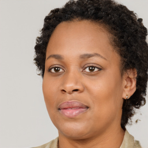 Joyful black young-adult female with medium  brown hair and brown eyes
