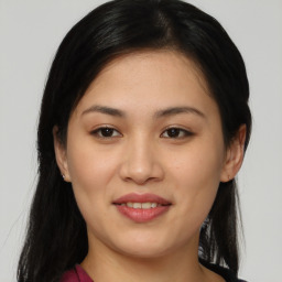 Joyful asian young-adult female with long  black hair and brown eyes