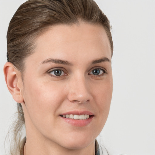 Joyful white young-adult female with medium  brown hair and grey eyes