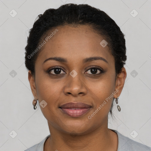 Joyful black young-adult female with short  black hair and brown eyes