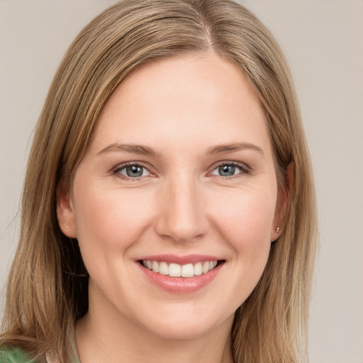 Joyful white young-adult female with long  brown hair and green eyes