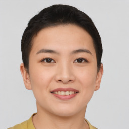 Joyful asian young-adult female with short  brown hair and brown eyes