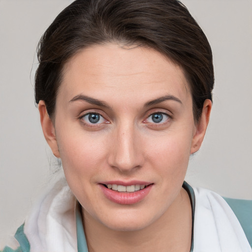 Joyful white young-adult female with medium  brown hair and grey eyes