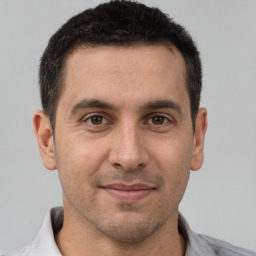 Joyful white adult male with short  brown hair and brown eyes