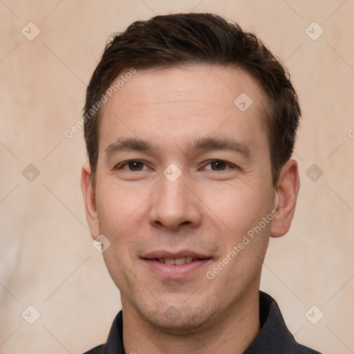 Joyful white adult male with short  brown hair and brown eyes