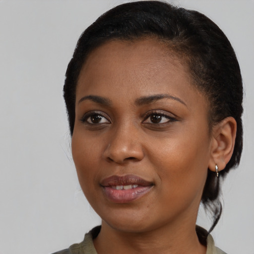 Joyful black young-adult female with medium  brown hair and brown eyes