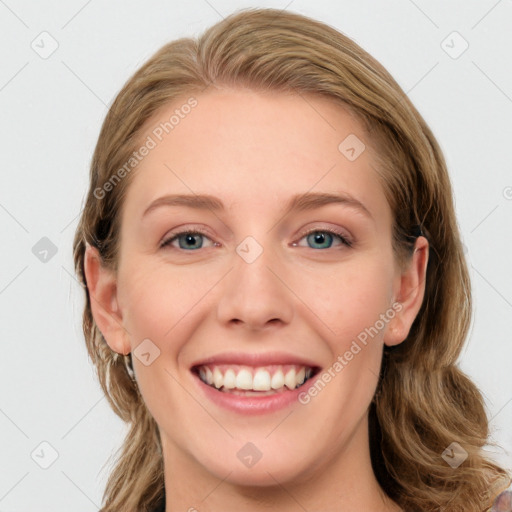 Joyful white young-adult female with long  brown hair and blue eyes