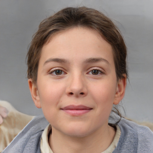 Joyful white child female with short  brown hair and brown eyes