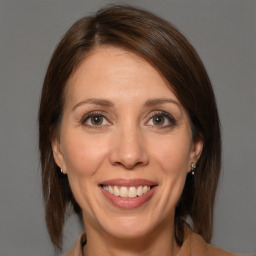 Joyful white adult female with medium  brown hair and brown eyes