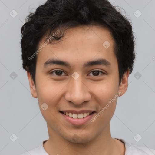 Joyful latino young-adult male with short  brown hair and brown eyes