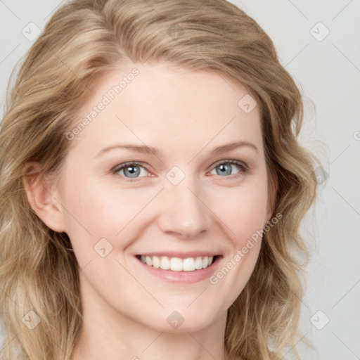 Joyful white young-adult female with long  brown hair and blue eyes