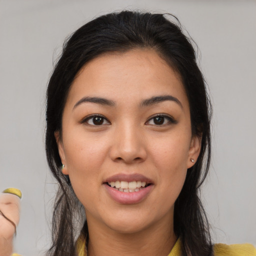 Joyful asian young-adult female with medium  brown hair and brown eyes