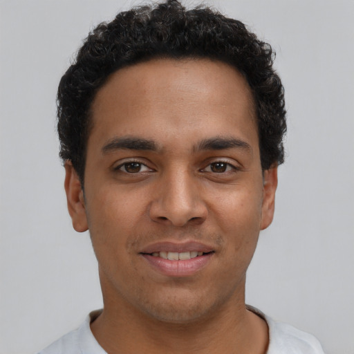 Joyful latino young-adult male with short  brown hair and brown eyes