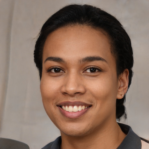 Joyful latino young-adult female with medium  black hair and brown eyes