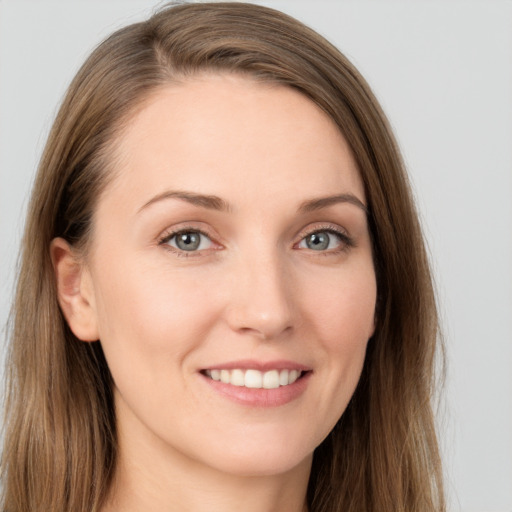 Joyful white young-adult female with long  brown hair and grey eyes