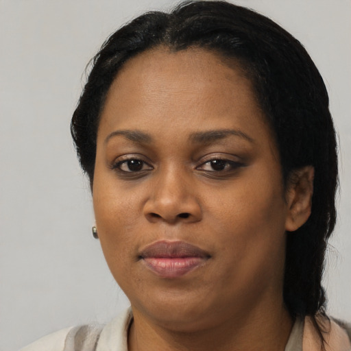 Joyful black adult female with short  black hair and brown eyes