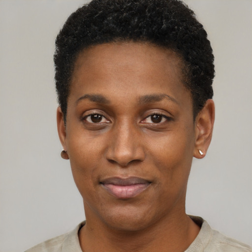 Joyful black young-adult female with short  black hair and brown eyes