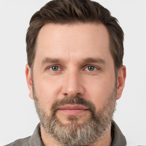 Joyful white adult male with short  brown hair and grey eyes