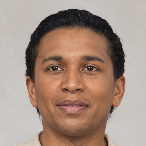 Joyful latino adult male with short  black hair and brown eyes