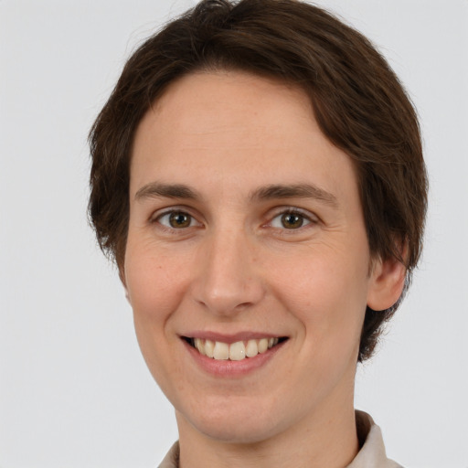 Joyful white young-adult female with short  brown hair and grey eyes