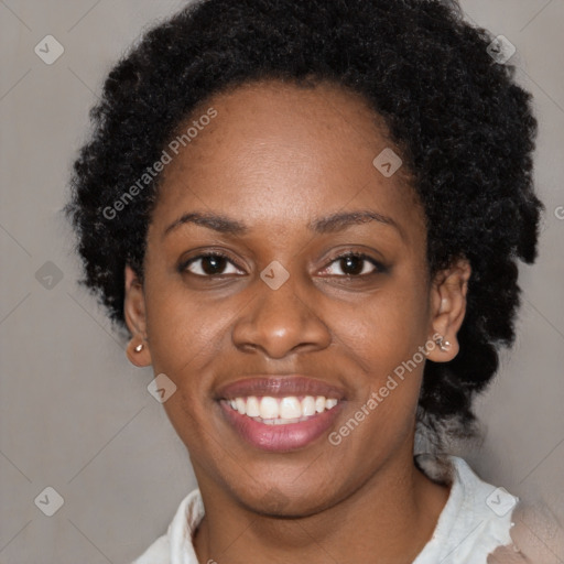 Joyful black young-adult female with short  black hair and brown eyes