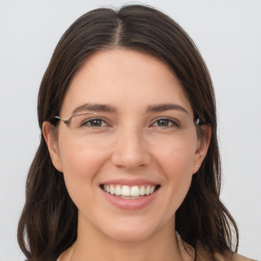 Joyful white young-adult female with long  brown hair and grey eyes