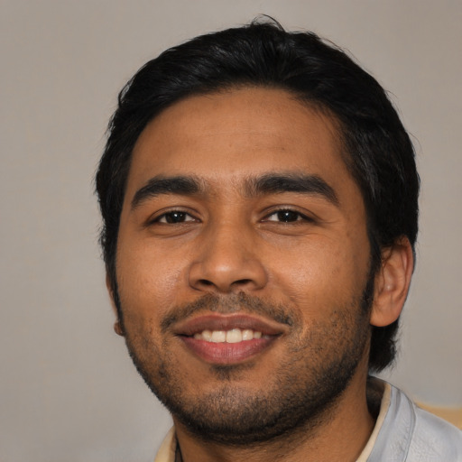 Joyful asian young-adult male with short  black hair and brown eyes