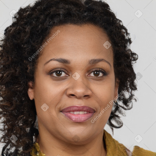 Joyful black adult female with medium  brown hair and brown eyes