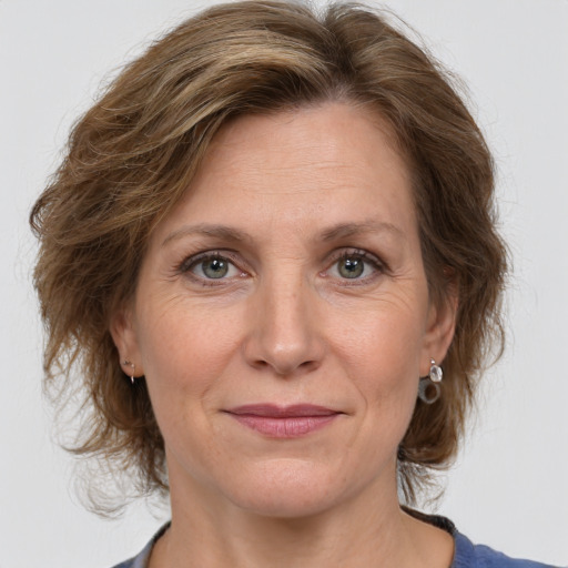 Joyful white adult female with medium  brown hair and grey eyes