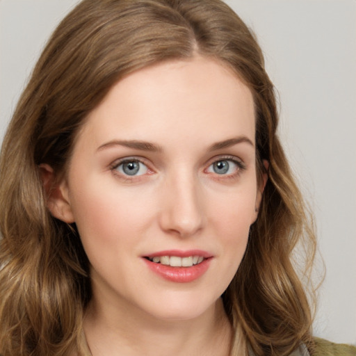 Joyful white young-adult female with long  brown hair and green eyes