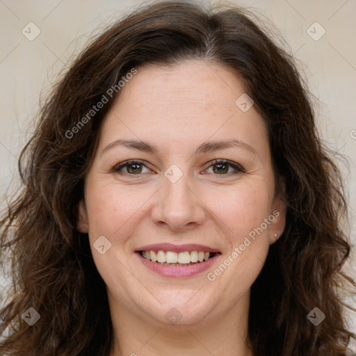 Joyful white adult female with long  brown hair and brown eyes