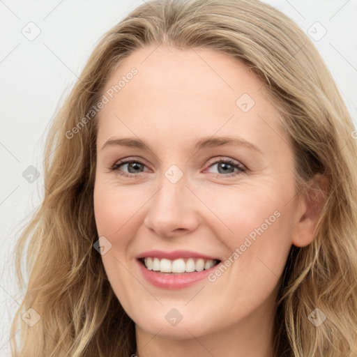 Joyful white young-adult female with long  brown hair and blue eyes