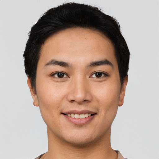 Joyful asian young-adult male with short  black hair and brown eyes