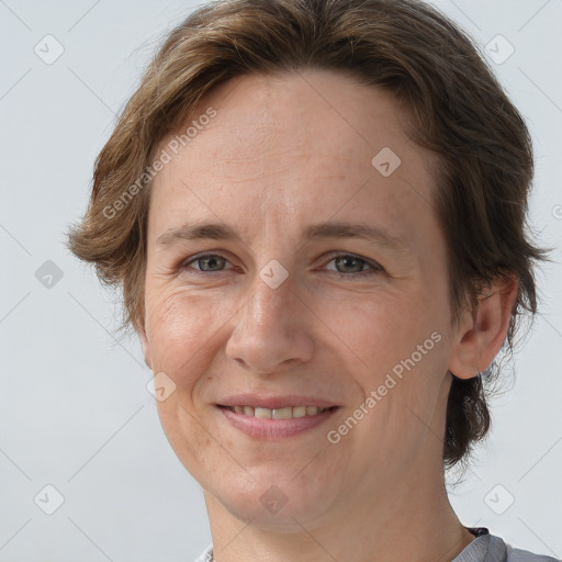 Joyful white adult female with short  brown hair and grey eyes