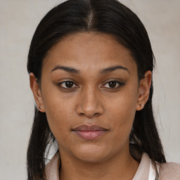 Joyful latino young-adult female with medium  brown hair and brown eyes