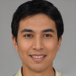 Joyful asian young-adult male with short  brown hair and brown eyes