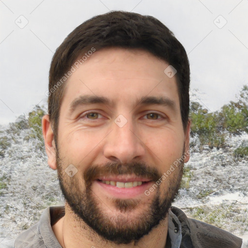 Joyful white adult male with short  brown hair and brown eyes