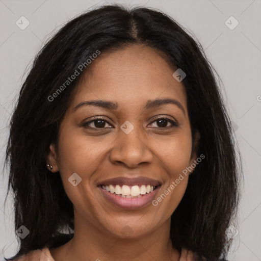 Joyful black young-adult female with long  brown hair and brown eyes