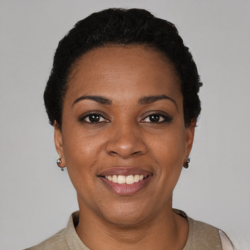 Joyful black young-adult female with short  black hair and brown eyes