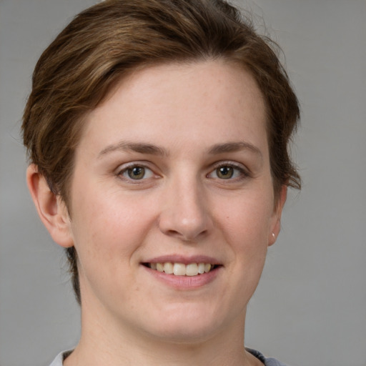 Joyful white young-adult female with short  brown hair and grey eyes