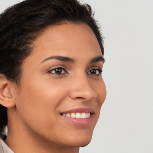 Joyful latino young-adult female with short  brown hair and brown eyes