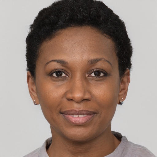 Joyful black adult female with short  black hair and brown eyes