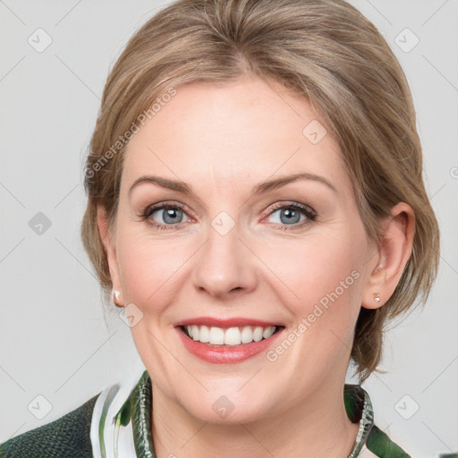 Joyful white adult female with medium  brown hair and green eyes