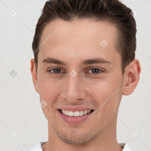 Joyful white young-adult male with short  brown hair and brown eyes