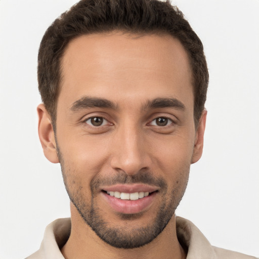 Joyful white young-adult male with short  brown hair and brown eyes