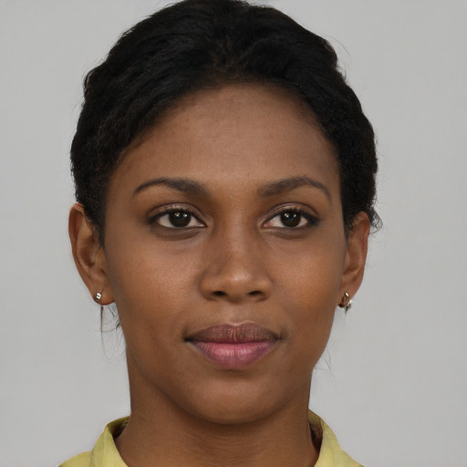 Joyful black young-adult female with short  brown hair and brown eyes