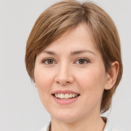 Joyful white young-adult female with medium  brown hair and grey eyes