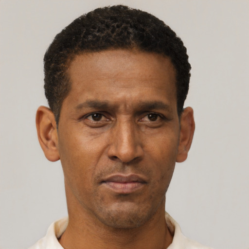 Neutral latino adult male with short  black hair and brown eyes