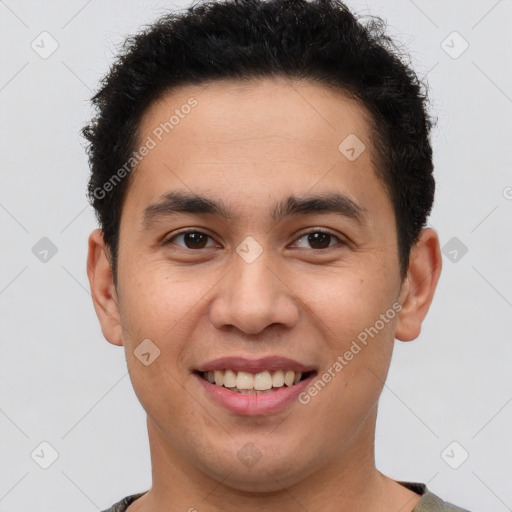 Joyful latino young-adult male with short  brown hair and brown eyes